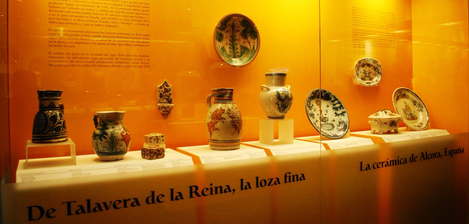 A display of glazed Talavera pottery in blue, white, and yellow.
